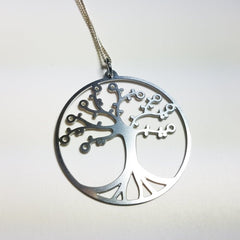 Cherry Tree of Life pendant on leather cord by DC-GioGio Design, featuring intricate tree design and natural wood finish.