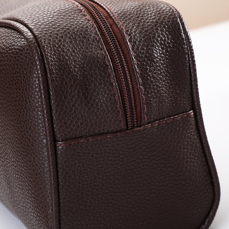 Men's travel cosmetic bag by Zen, made of PU leather, featuring multiple compartments for toiletries and grooming essentials.