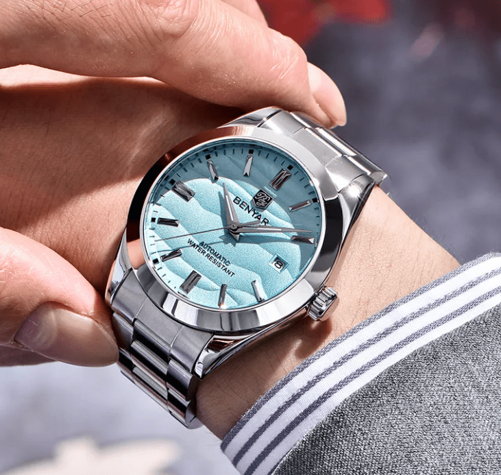 Luminous men's mechanical watch by Zen with a stainless steel band and round dial, showcasing elegant jewelry craftsmanship.