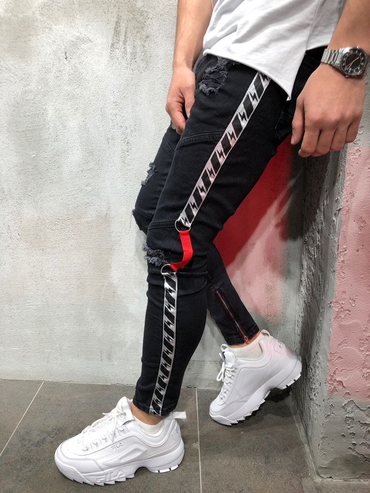 Men's Ribbon Jeans by Memories but Unique, denim pants with ribbon details, shown on a model in a casual pose.