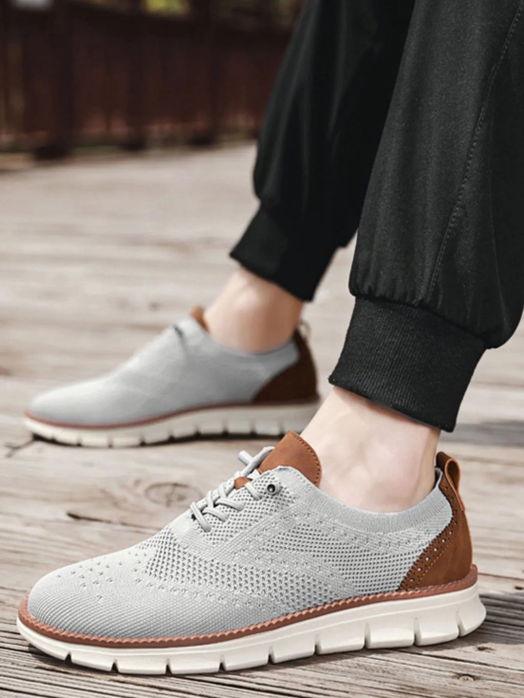 Men's breathable mesh and PU leather athletic sneakers with lace-up closure and rubber sole, designed for comfort and style.