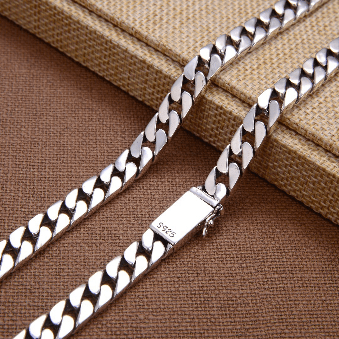 Men's fashion chain clutch in black with silver chain detail, featuring a sleek design and compact size for stylish accessories.