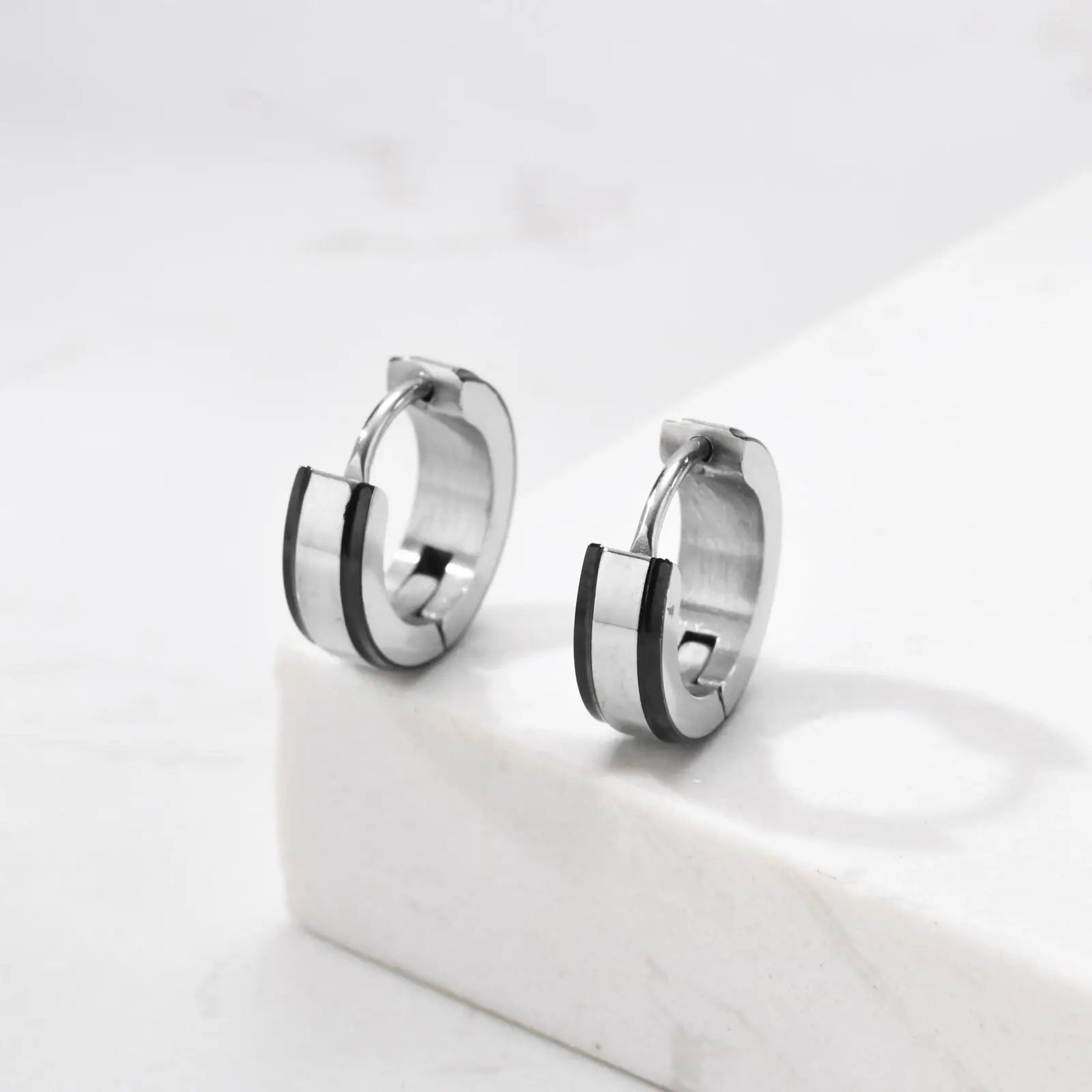 Simple men's stainless steel circle huggies hoop earrings, casual jewelry by Memories but Unique, showcasing a sleek, modern design.