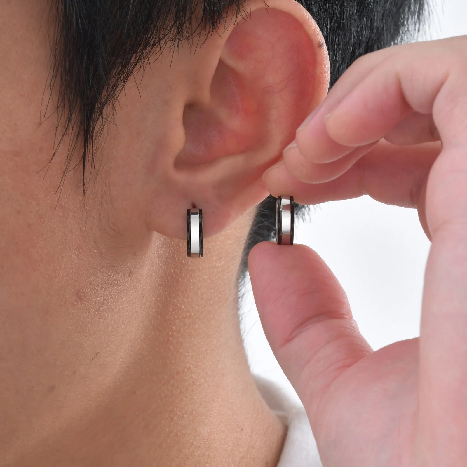 Simple men's stainless steel circle huggie earrings, casual jewelry by Memories but Unique, close-up of classic hoop design