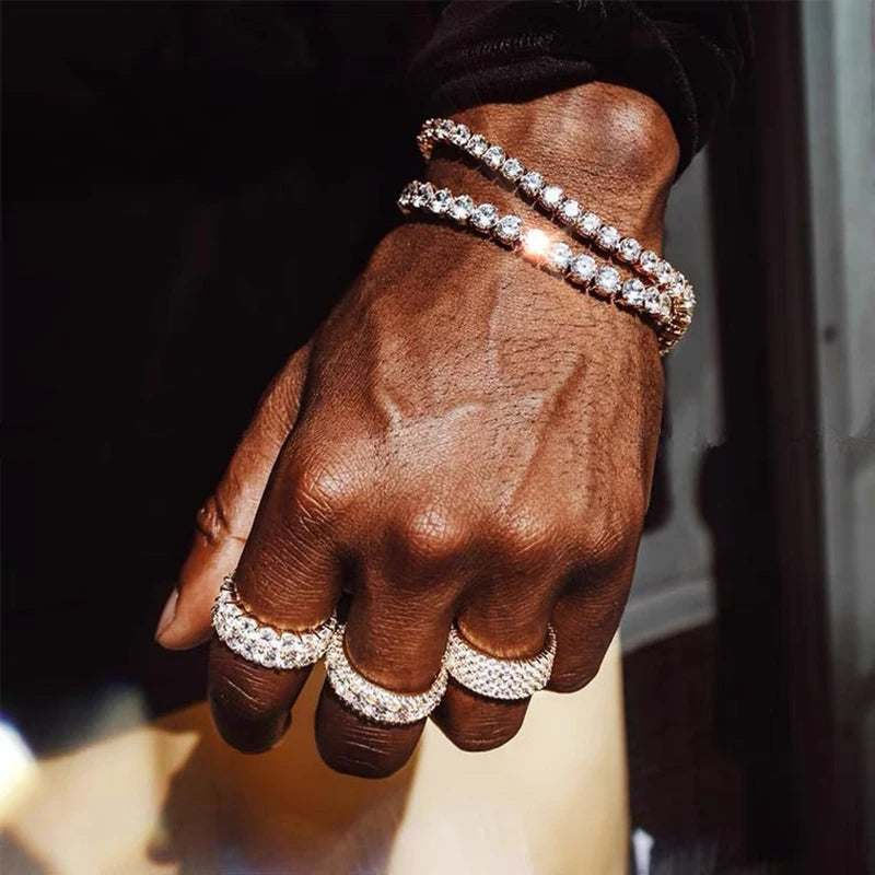 Iced out hip-hop tennis bracelet with cubic zirconia stones, 3/4/5mm chain, styled on a man's hand, streetwear men's jewelry.