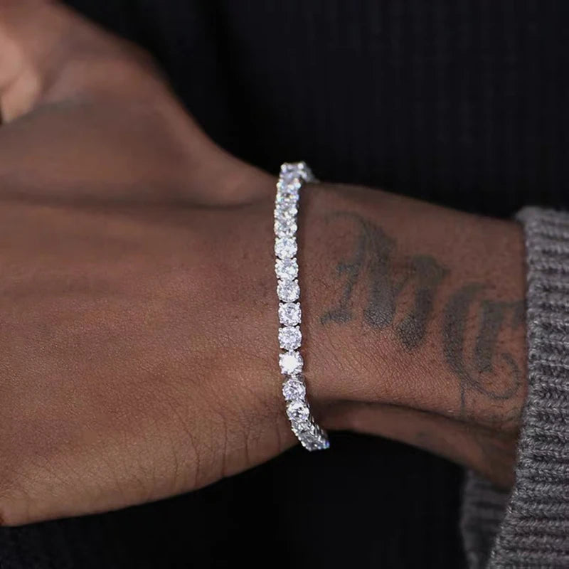 Men's iced out hip-hop tennis bracelet with cubic zirconia stones, 3/4/5mm crystal chain, on male hand, streetwear jewelry.