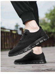 Men's breathable mesh and PU leather athletic sneakers with rubber soles, featuring lace-up design for active wear by Trendsi
