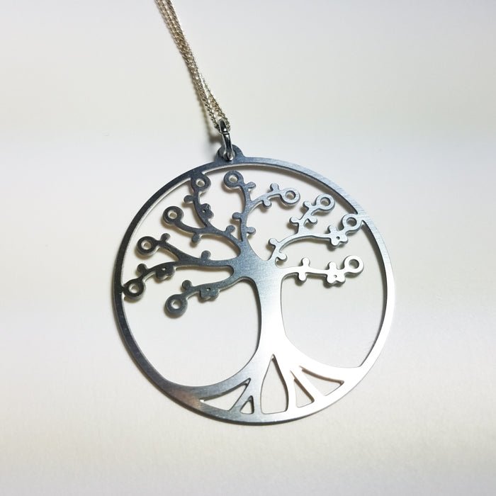 Cherry Tree of Life pendant on leather cord by DC-GioGio Design, featuring intricate tree design and natural wood finish.